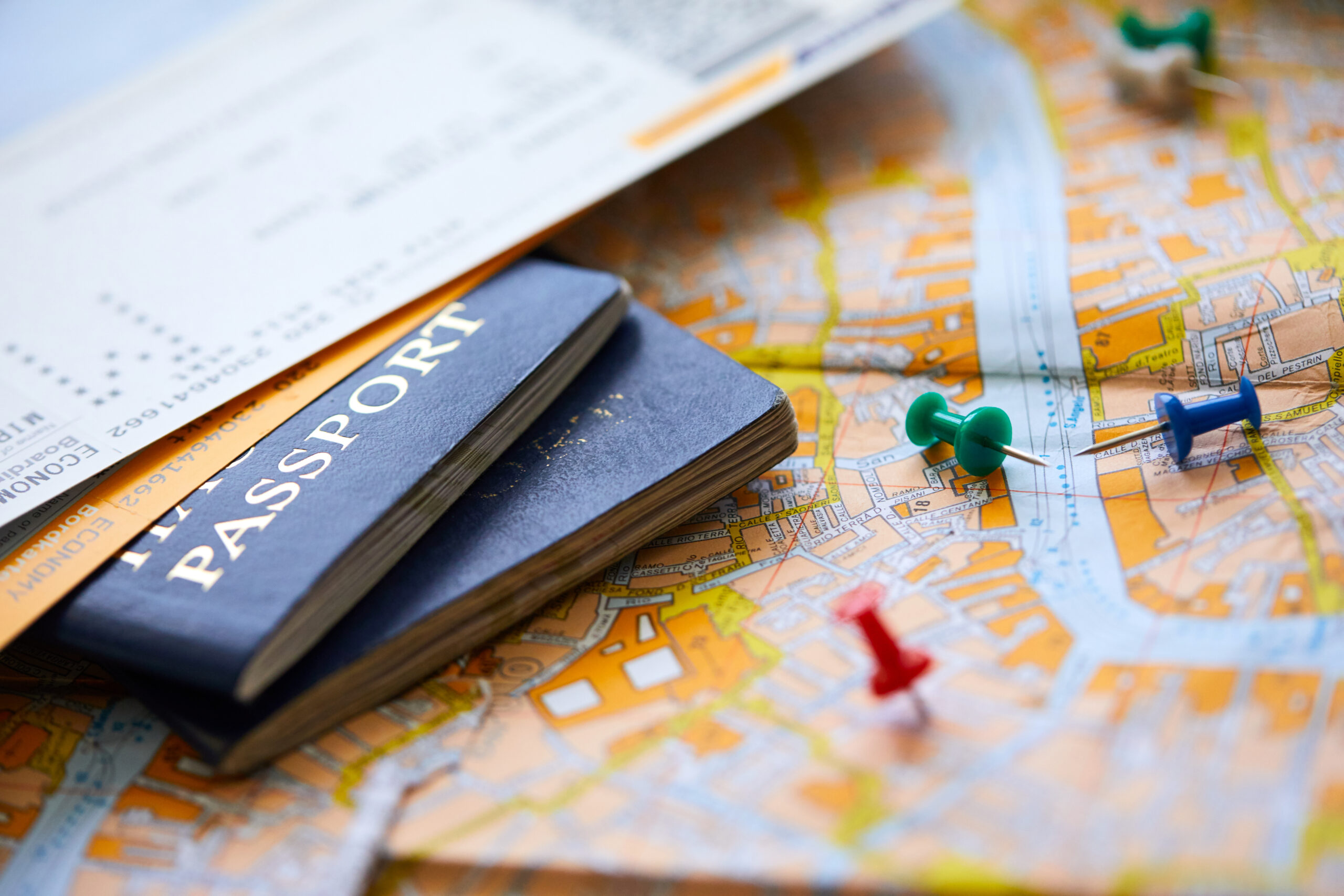 pins marking travel itinerary points on map and passport pins marking travel itinerary points on map and passport